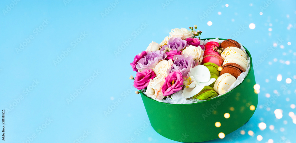 Festive box with rosebuds in full bloom on blue background. Valentines Day. Close-up