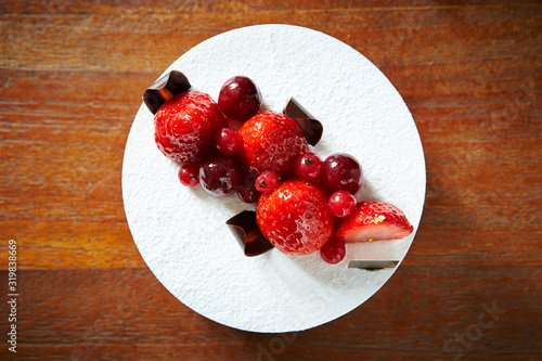 Berry cake on wooden background 