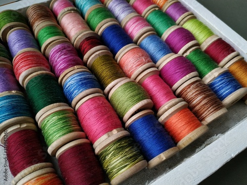 Colorful spools of thread. Multicolor motley background. 