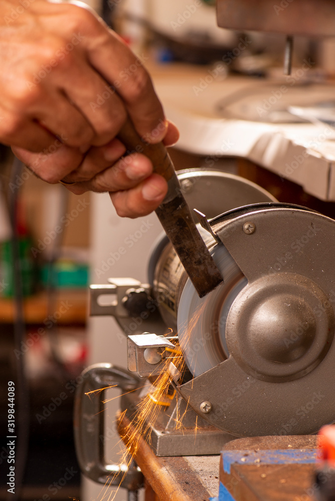luthier using grinder to prepare metal part luthier using grinder to prepare metal part