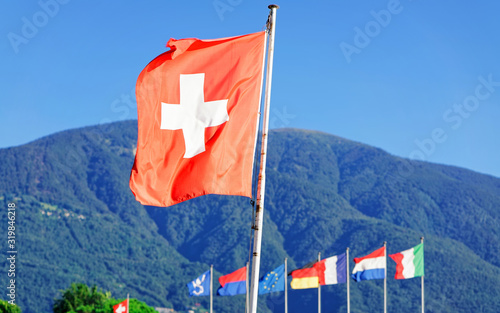 Flags in Ascona, Ticino canton in Switzerland. Swiss Alps on the background