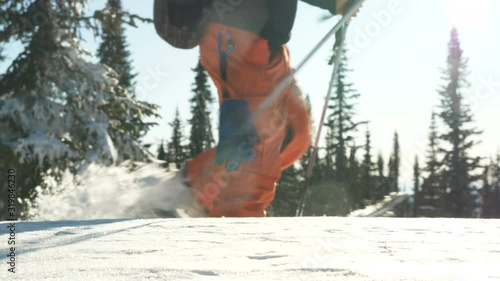 Two skiers go downhill skiing in a snowy forest in the mountains close up, go in for skiing and freeride