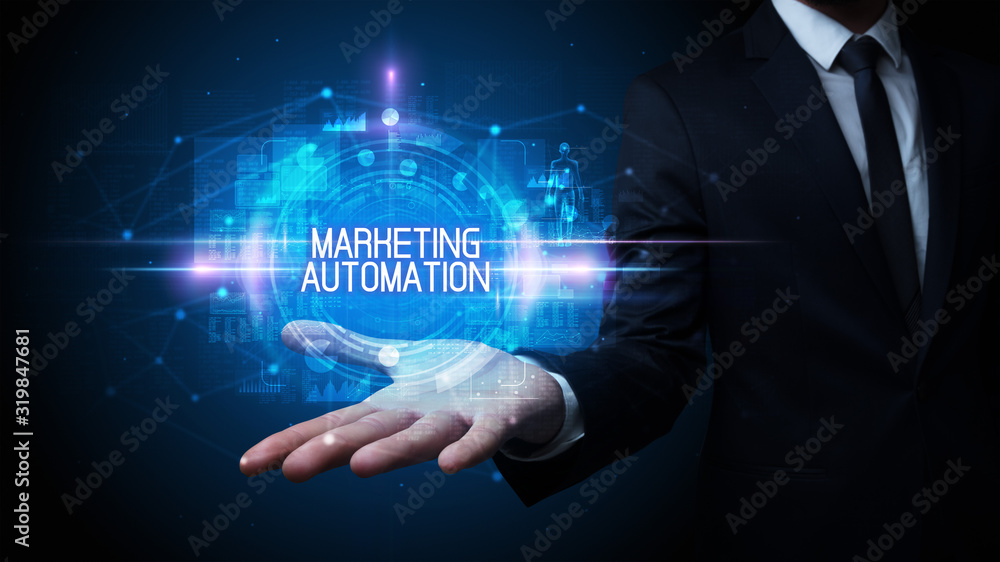 Man hand holding MARKETING AUTOMATION inscription, technology concept Man hand holding MARKETING AUTOMATION inscription, technology concept