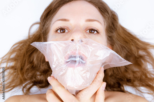 Obraz na plátne The girl is suffocating because of a plastic bag on her face