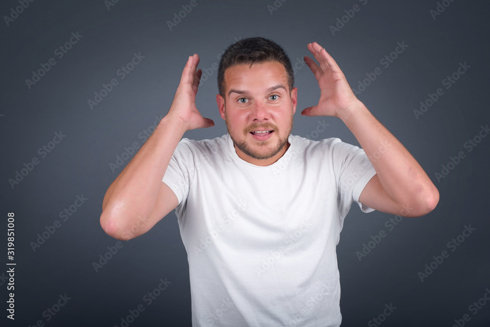 Excited overjoyed man screams after recieving good news, keeps hands on head, can't believe it. Excited overjoyed man screams after recieving good news, keeps hands on head, can't believe it.