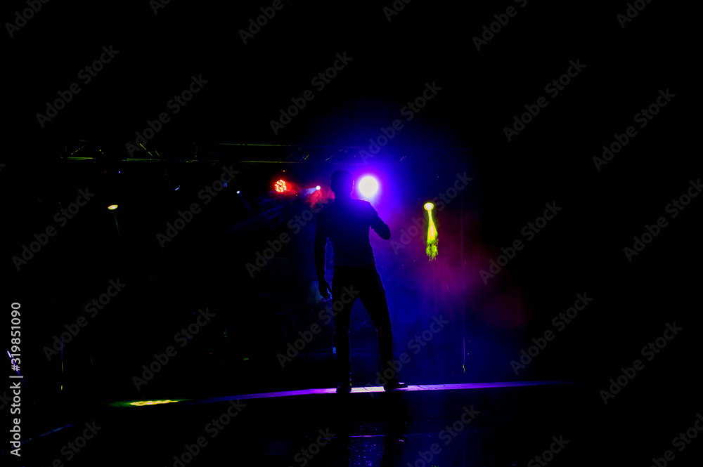 Dark silhouette of a singer on the stage.