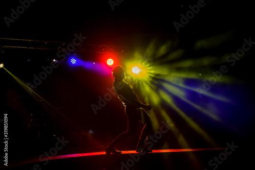 Dark silhouette of a singer on the stage.