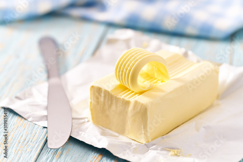whole block butter on a blue wooden table, selective focus.