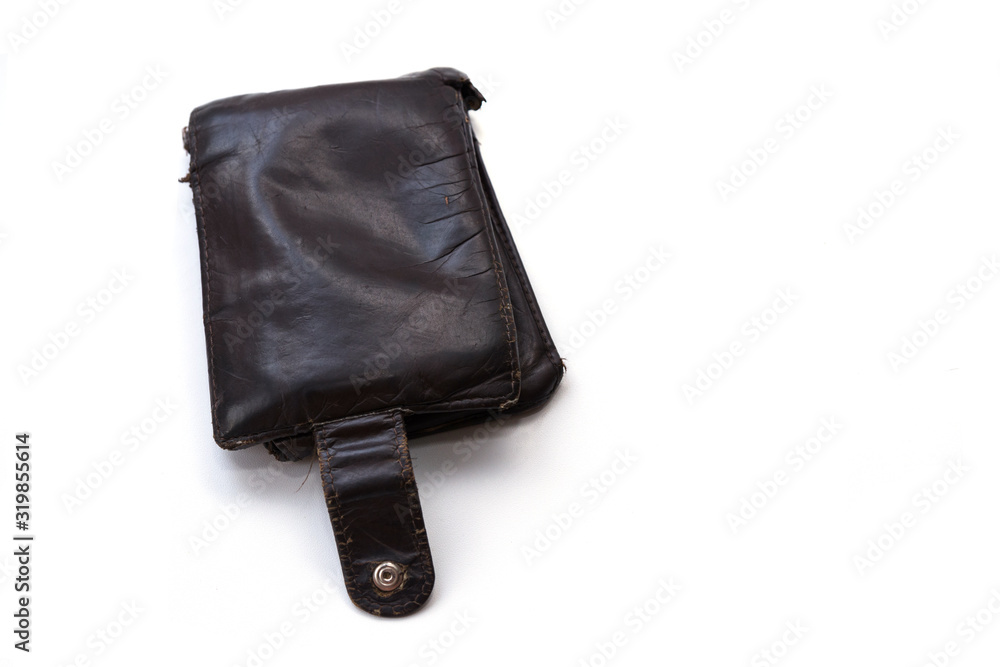 An old, worn, scratched and torn wallet made of genuine brown leather. The wallet is isolated on a white background. Poverty and need Concept. Copy space. An old, worn, scratched and torn wallet made of genuine brown leather. The wallet is isolated on a white background. Poverty and need Concept. Copy space.