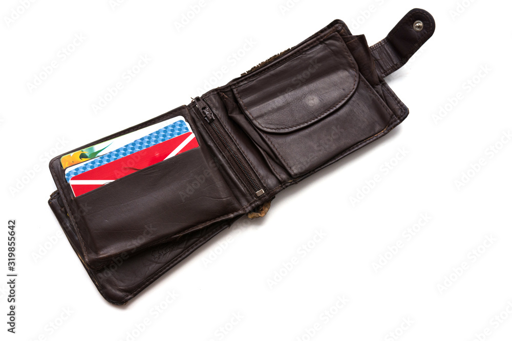 An old, worn, scratched and torn wallet made of genuine brown leather, isolated on a white background. The wallet is opened. Few various cards inside it. Poverty and need Concept. Copy space. An old, worn, scratched and torn wallet made of genuine brown leather, isolated on a white background. The wallet is opened. Few various cards inside it. Poverty and need Concept. Copy space.