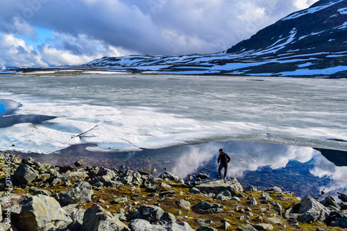 The tourist guy near snow road Aurlandsvegen. Norway. photo