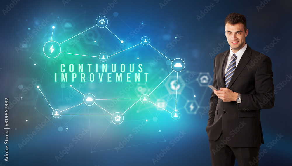 Businessman in front of cloud service icons with CONTINUOUS IMPROVEMENT inscription, modern technology concept Businessman in front of cloud service icons with CONTINUOUS IMPROVEMENT inscription, modern technology concept