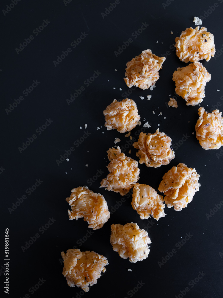 food, fried cheese breaded on a black background food, fried cheese breaded on a black background