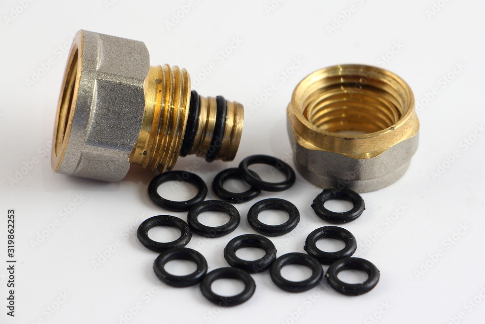 Replaceable little O-rings for Metal-plastic 16 mm fitting pipe connector repair close up, plumbing equipment on white background Replaceable little O-rings for Metal-plastic 16 mm fitting pipe connector repair close up, plumbing equipment on white background
