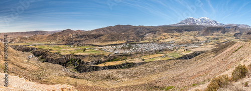A panoramic view over Putre village inside a valley at Andes mountains. An amazing and idyllic scenery inside the Andes Altiplano at the driest desert in the world  Atacama