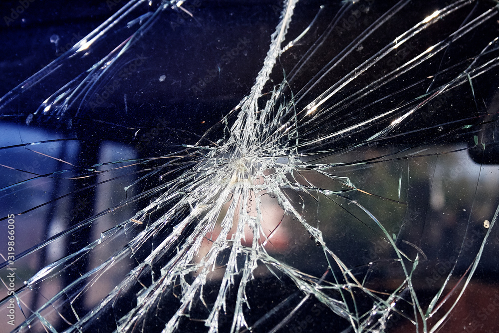 Close-up broken car windshield. Tint blue Close-up broken car windshield. Tint blue