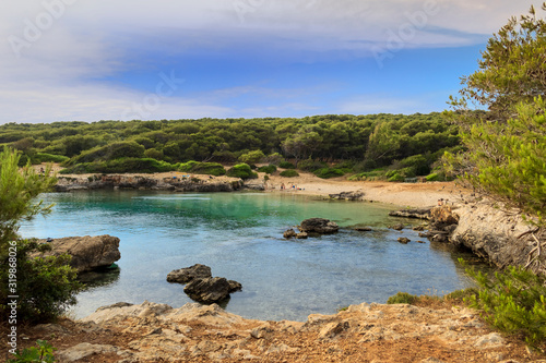 Salento: pebble beach of the Regional Natural Park Porto Selvaggio and Palude del Capitano in Puglia (Italy) near Nardò town: the coast is rocky and jagged, with pine forests and Mediterranean scrub.