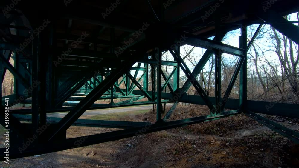 Right truck moving under green iron road bridge steel frame construction Right truck moving under green iron road bridge steel frame construction