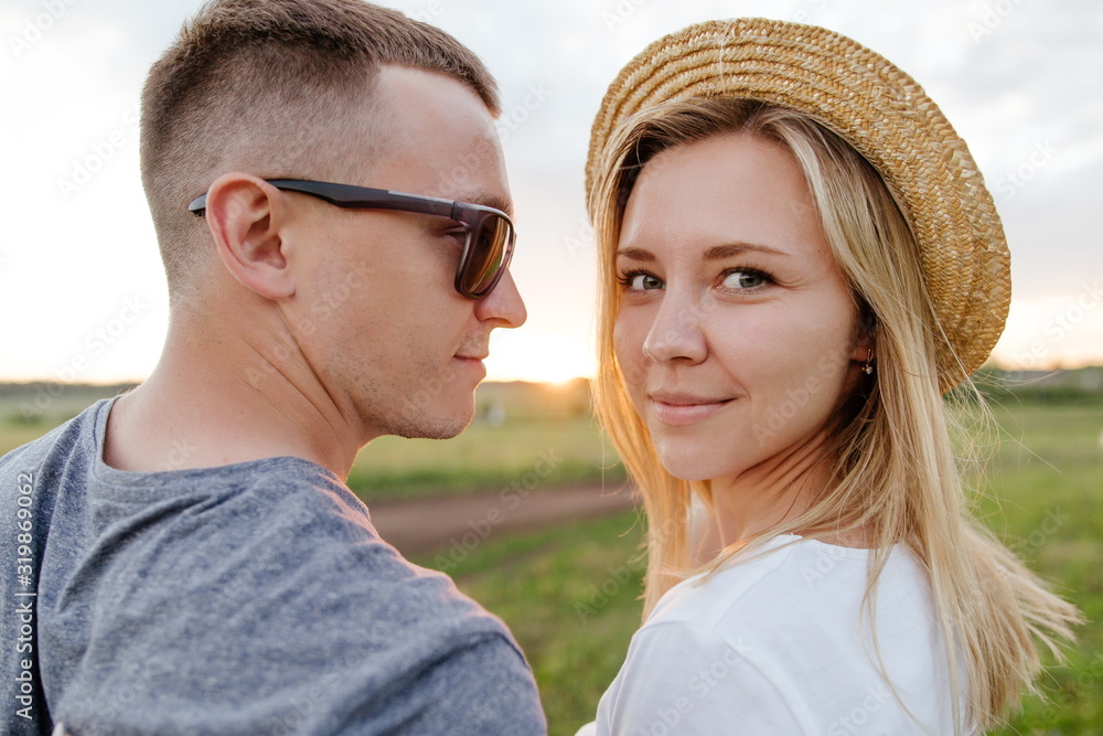 Fototapeta premium Portrait of a young couple at sunset