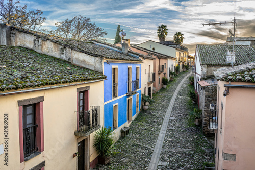 Sunset view at a medieval age town in Extremadura, Spain. A diminishing perspective view of the street and houses of the historical Granadilla town 