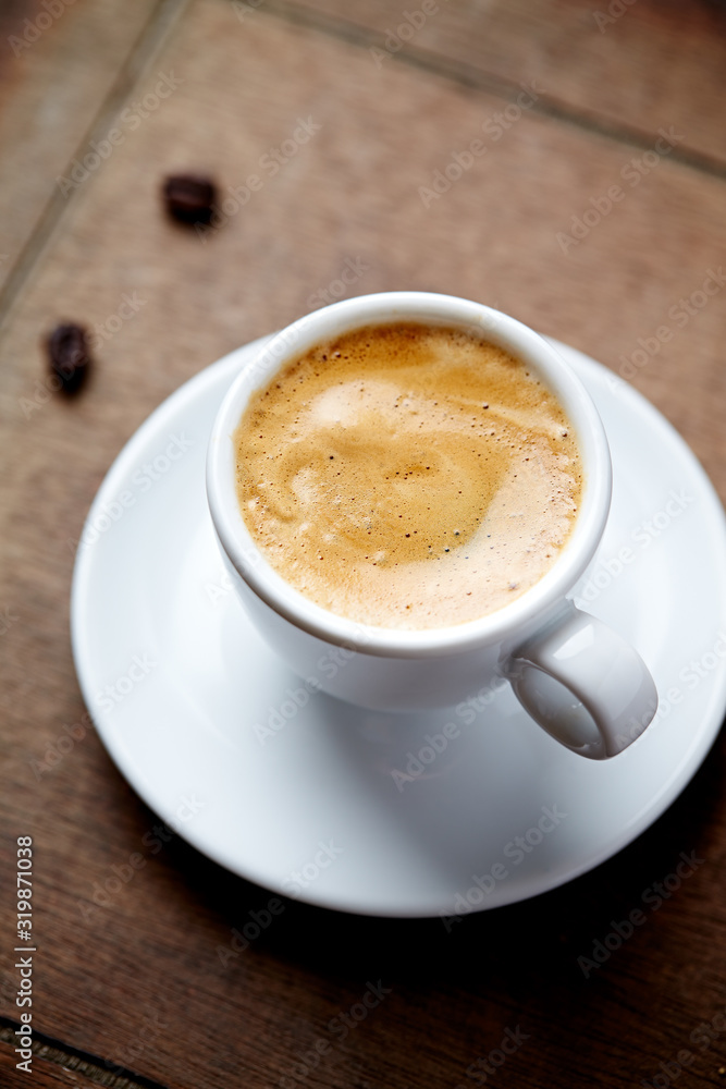 Cup of coffee on brown wooden background. Cup of coffee on brown wooden background.
