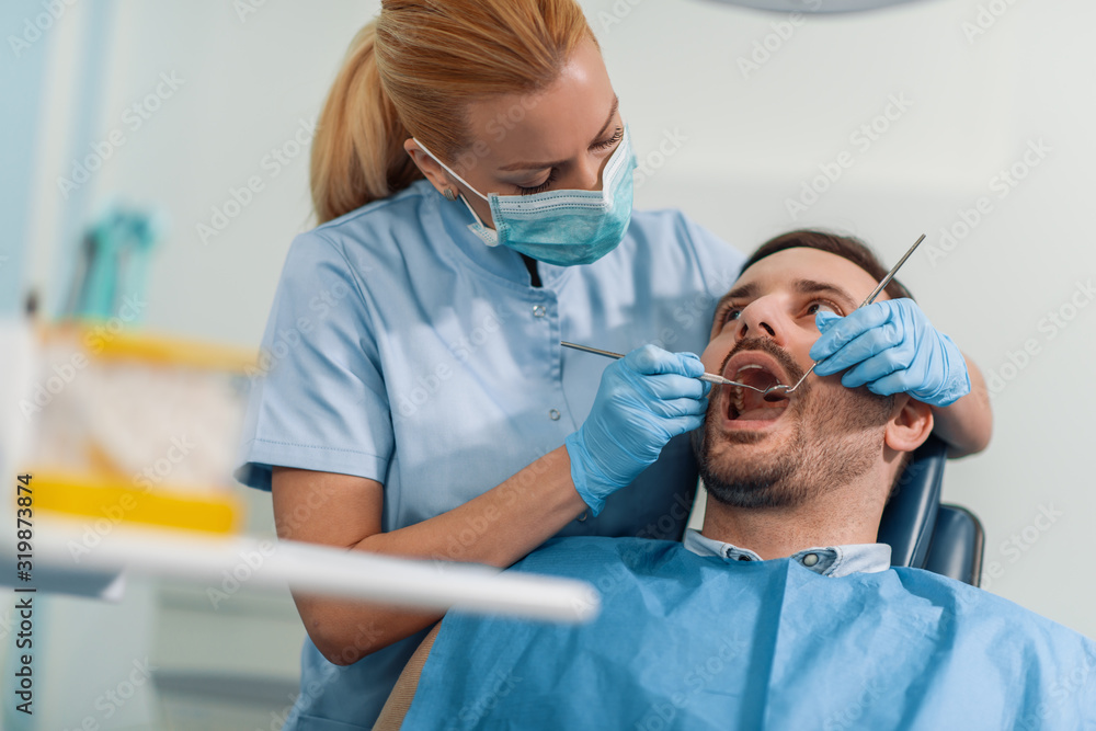 Dentist and patient in dentist office Dentist and patient in dentist office