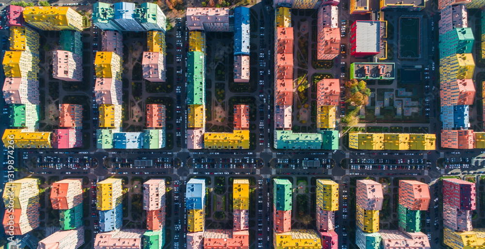 Urban landscape of colorful buildings. Aerial view of the colorful buildings in the European city in the morning sunlight. Cityscape with multicolored houses, cars on the street in Kiev, Ukraine.