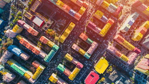 Urban landscape of colorful buildings. Aerial view of the colorful buildings in the European city in the morning sunlight. Cityscape with multicolored houses  cars on the street in Kiev  Ukraine.