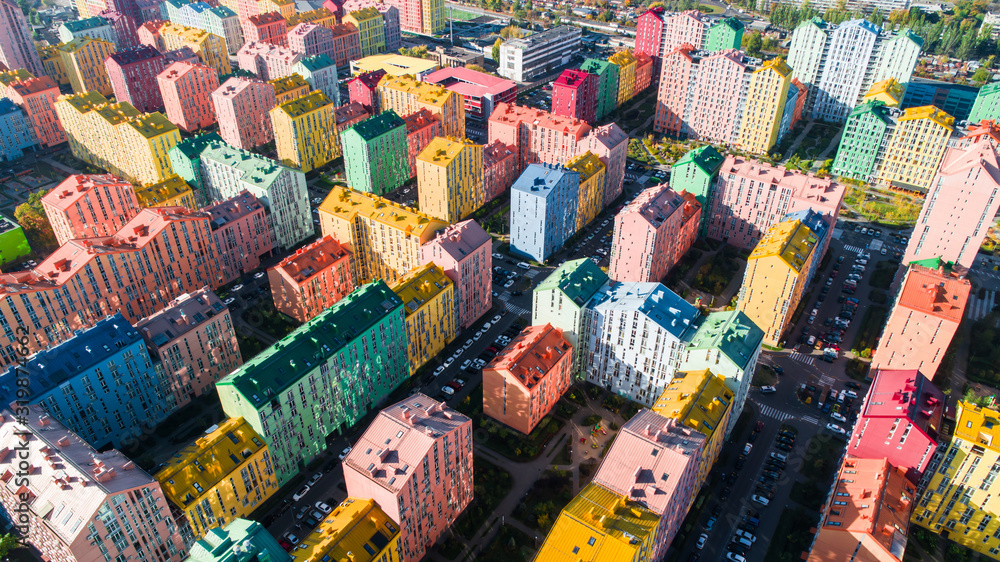 Urban landscape of colorful buildings. Aerial view of the colorful buildings in the European city in the morning sunlight. Cityscape with multicolored houses, cars on the street in Kiev, Ukraine.