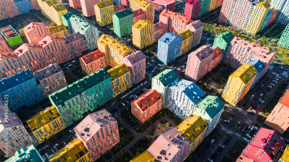 Urban landscape of colorful buildings. Aerial view of the colorful buildings in the European city in the morning sunlight. Cityscape with multicolored houses, cars on the street in Kiev, Ukraine.