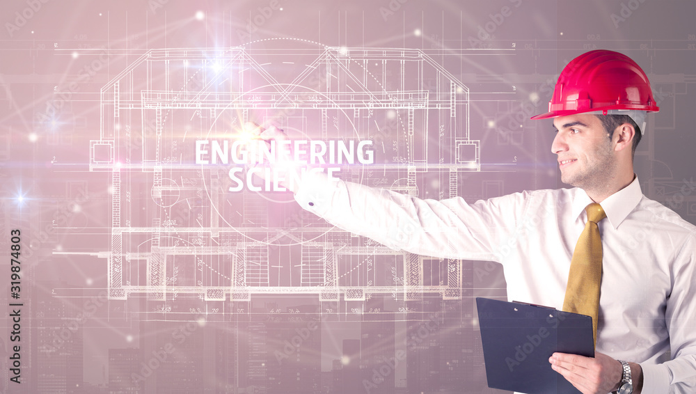 Handsome architect with helmet drawing ENGINEERING SCIENCE inscription, new technology concept Handsome architect with helmet drawing ENGINEERING SCIENCE inscription, new technology concept