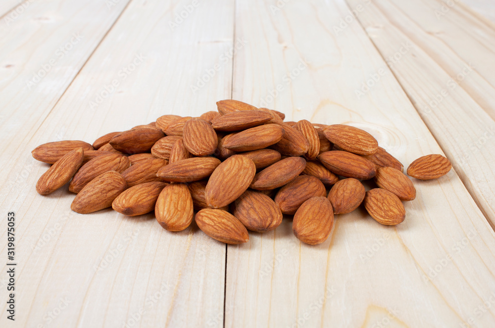 Almond isolated on wooden table Almond isolated on wooden table