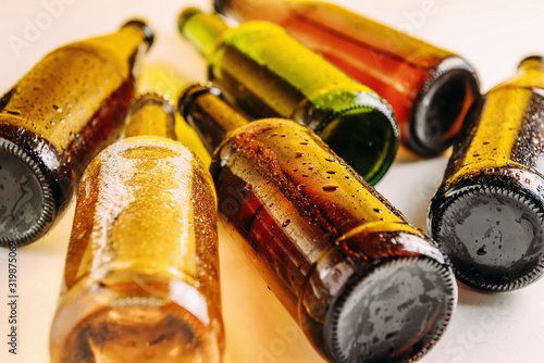 Bottles of beer in different colors. Light and dark beer. Beer background for advertising, chilled drink