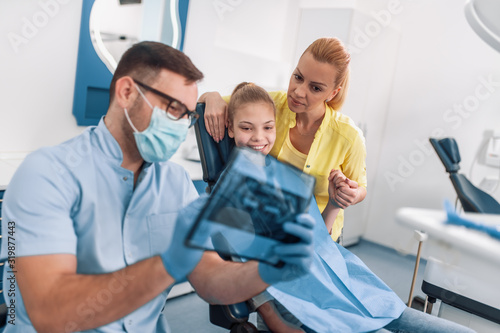 Dentist and patient looking to x-ray