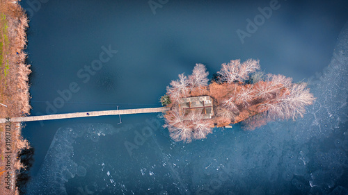 Morning landscape, wooden hunting lodge, on a small man-made island. photo