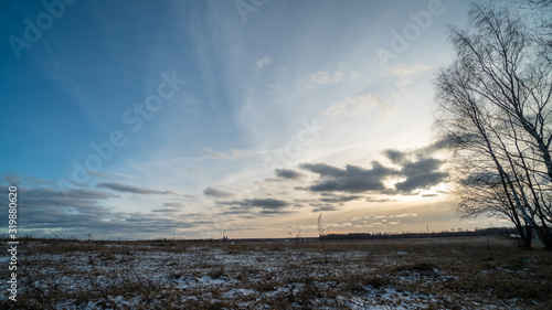 Beautiful setting sun over frozen field