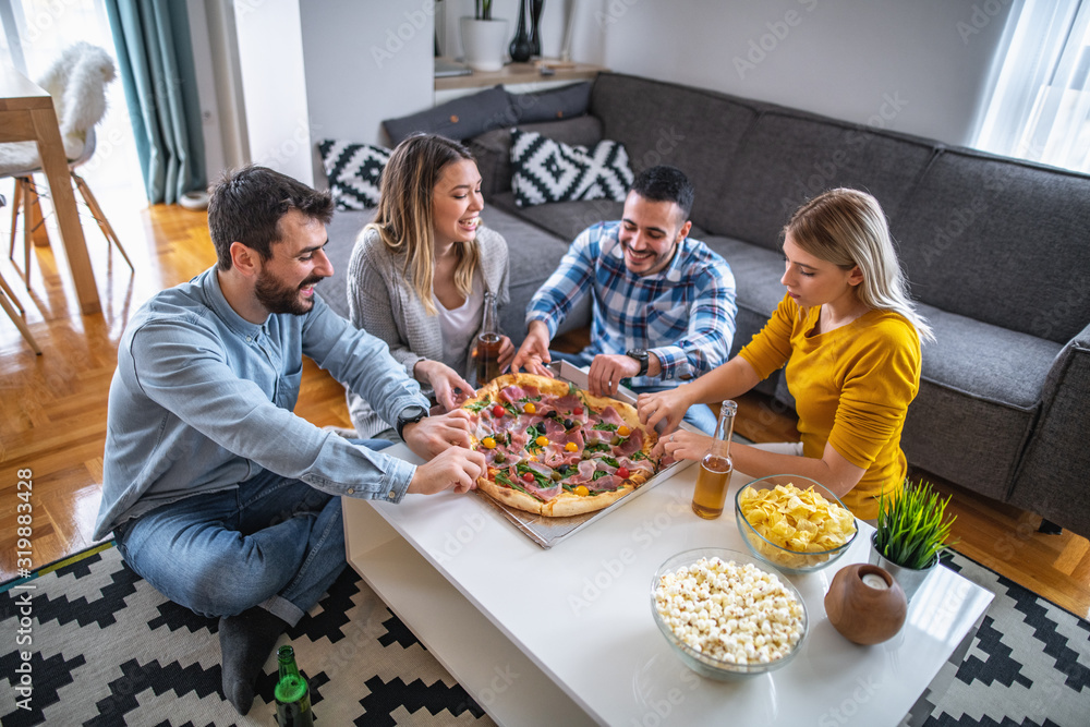 People having party at home and eating pizza