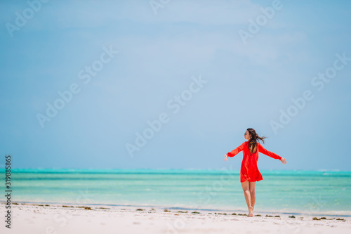 Woman laying on the beach enjoying summer holidays looking at the sea