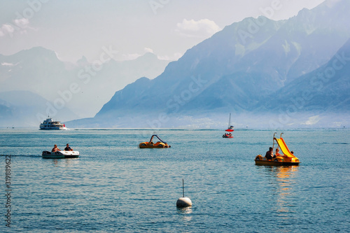 Lausanne, Switzerland - August 26, 2016: People in catamarans on Lake Geneva in Lausanne, Switzerland