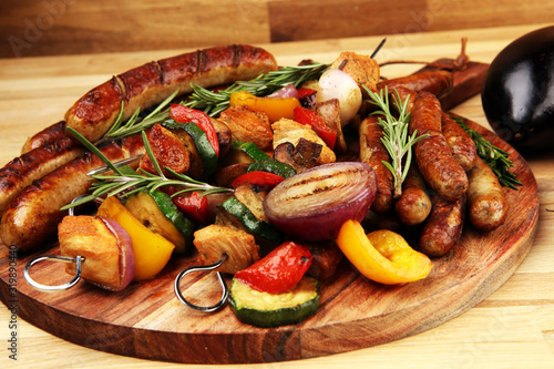Assorted delicious grilled meat with vegetable on a barbecue with Grilled pork shish or kebab on skewers with vegetables.