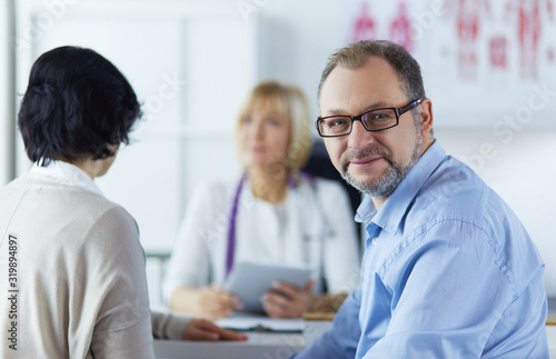 Smiling medical doctor and patient. Health care