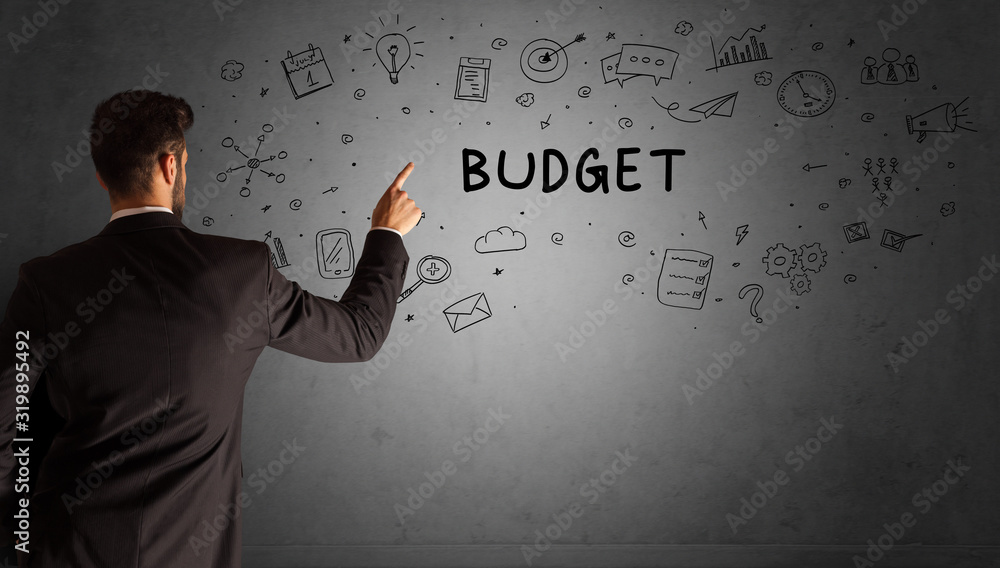 businessman drawing a creative idea sketch with BUDGET inscription, business strategy concept businessman drawing a creative idea sketch with BUDGET inscription, business strategy concept