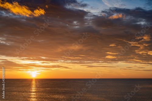 Fototapeta Naklejka Na Ścianę i Meble -  Early sunrise and epic cloudy sky above the sea. Coast of Torrevieja, Alicante, Spain. Mediterranean sea 2019