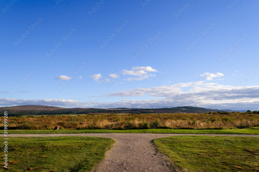 Concept of choice,:  footpath on a summer day with a blue sky located at Drummossie Moor near Inverness in the Scottish Highlands, the site of the Battle of Culloden in 1746.
