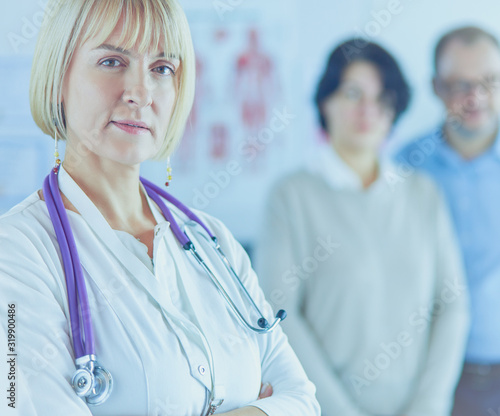 Smiling medical doctor with stethoscope and elderly couple