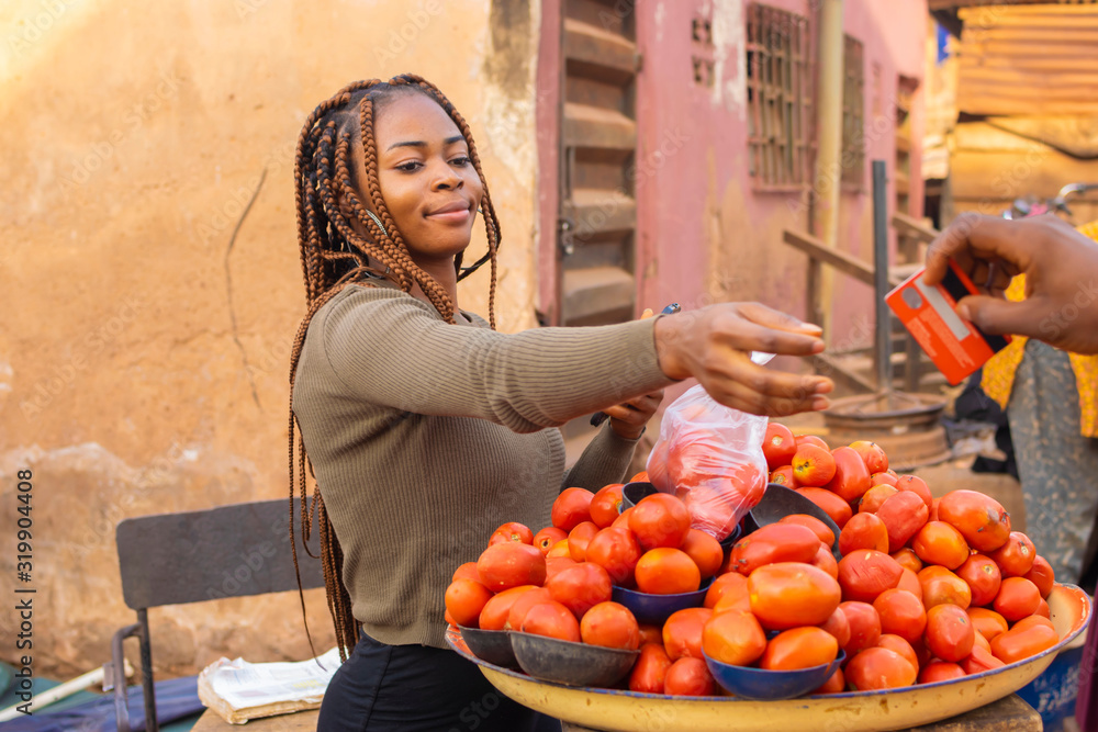 young black market woman doing her business in the market