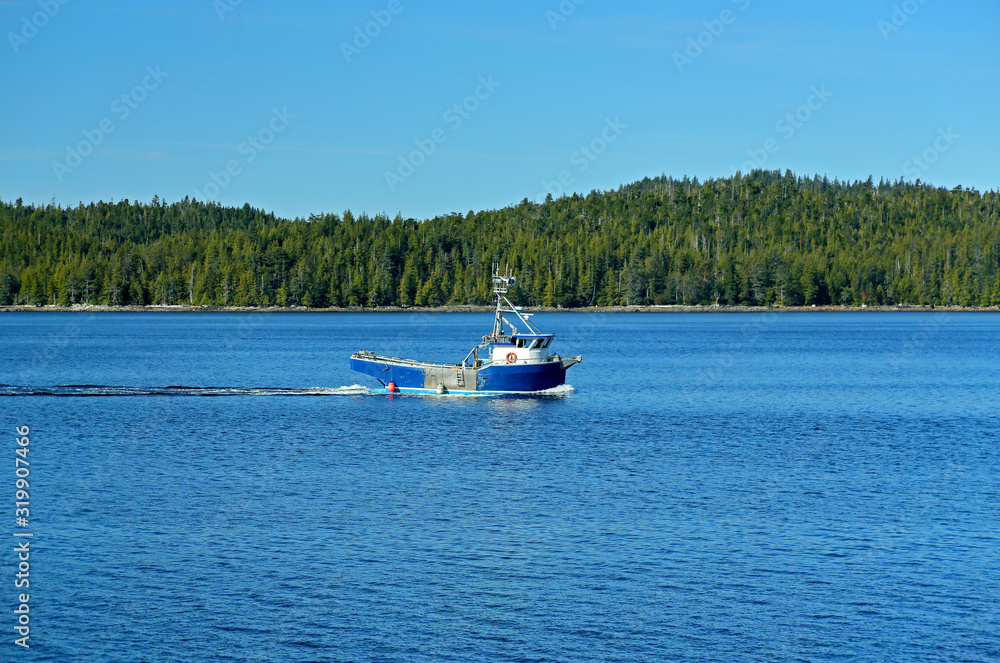 Obraz premium Boat on blue water with an island for background
