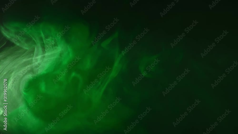 Green paint drops mixing in water slow motion. Smooth ink swirling and splashing from above underwater. Ink cloud on black background. Colored abstract smoke explosion. Green paint drops mixing in water slow motion. Smooth ink swirling and splashing from above underwater. Ink cloud on black background. Colored abstract smoke explosion.