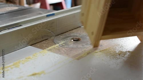 Close up of hands operate a router to cut wood