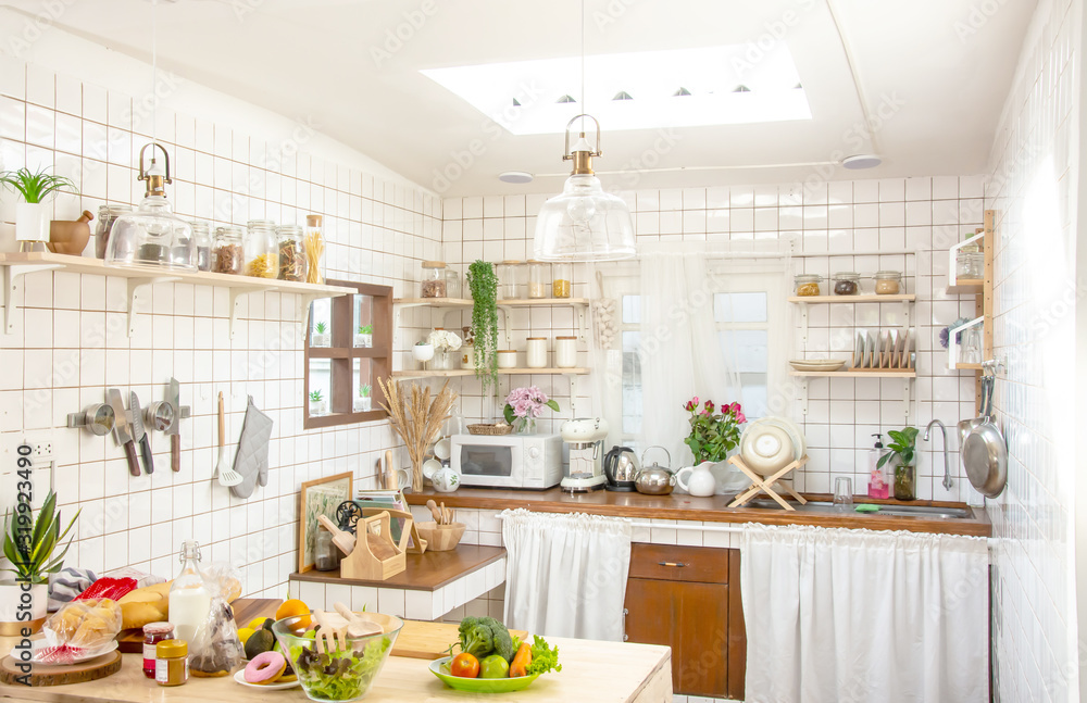 Fototapeta premium Beautiful Kitchen Interior with Island, Sink, Cabinets and Pendant Lights in New Home